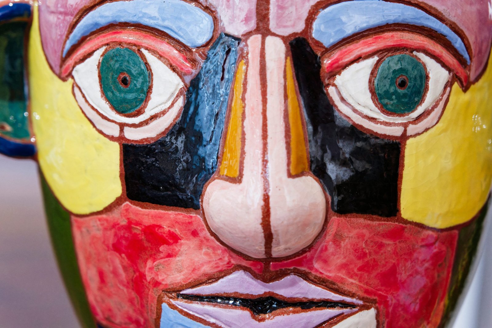 A close up of a colorful mask on display